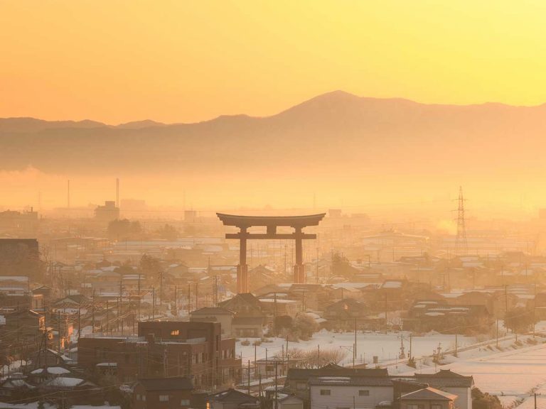 Japanese photog captures mystical scene of a torii gate standing in the golden mist of dawn