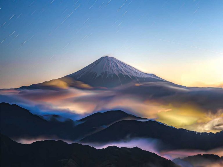 Photographer captures majestic shot of Mt. Fuji in swirling sea of colorful clouds