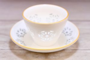These Japanese cups, saucers, and sake pitchers have beautiful translucent patterned designs
