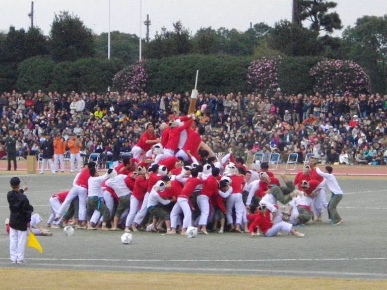 Bō-taoshi: a game of several hundred men trying to knock down a pole