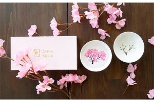 Elegant sakura Japanese sake cups bloom into colorful cherry blossoms with chilled sake